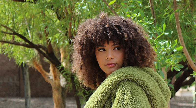 Woman staring off into the distance while wearing a green Nordic Beach wrap